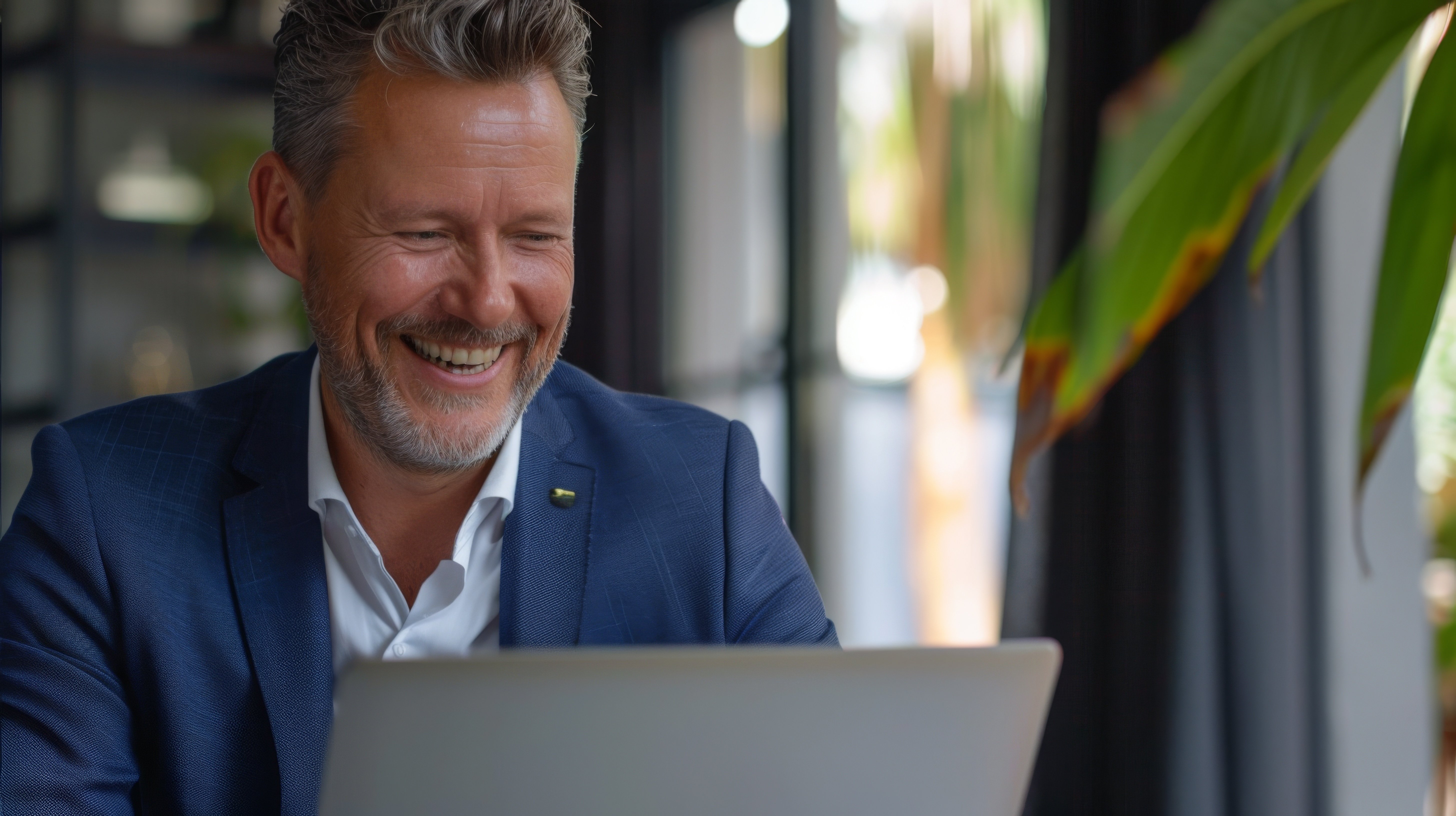 smiling-businessman-with-laptop