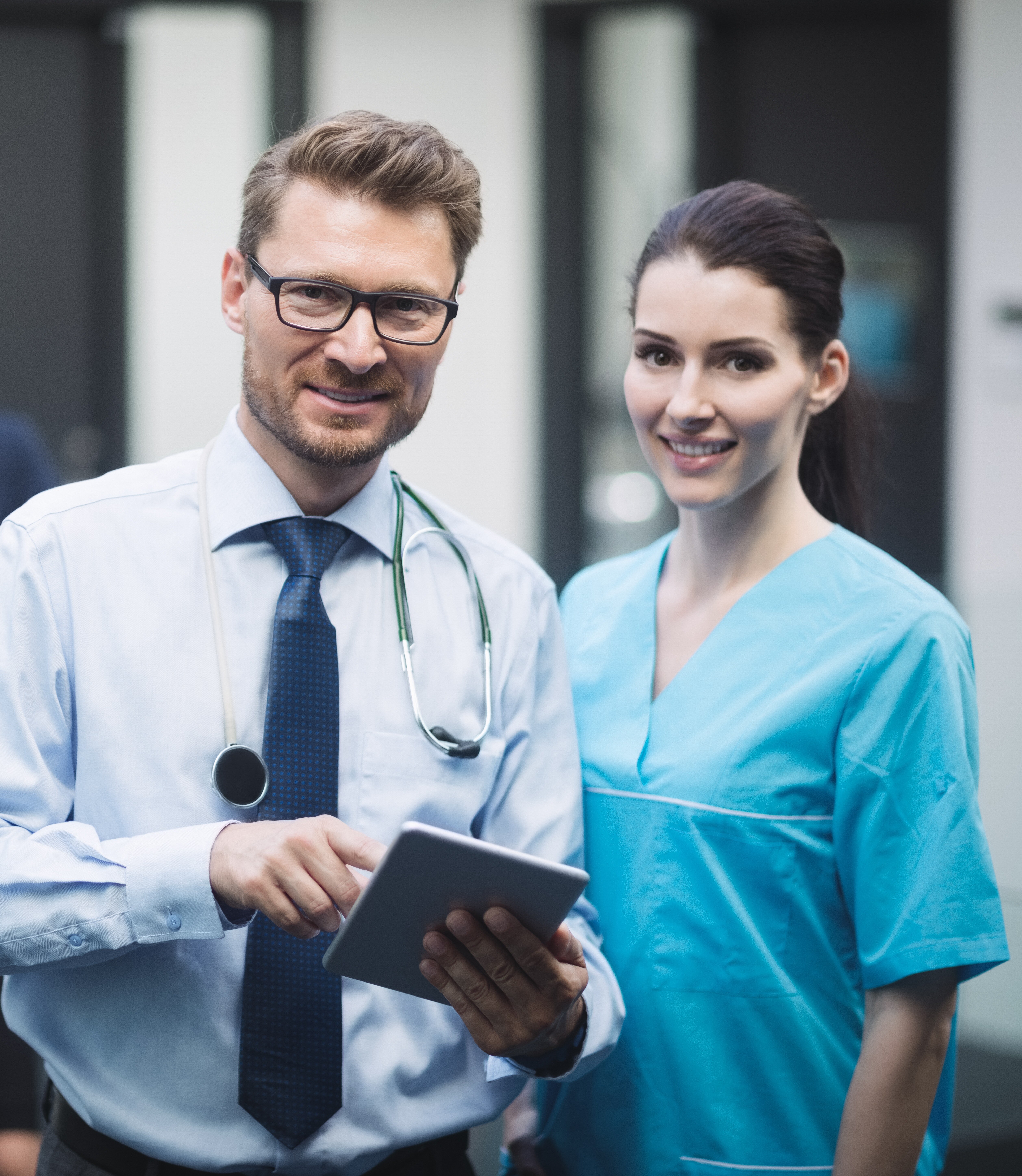 smiling-doctor-nurse-with-digital-tablet